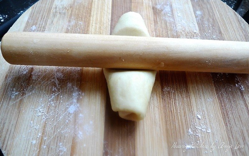 Plum Blossom Mooncake - Roll the dough flat again with a rolling pin and then roll up