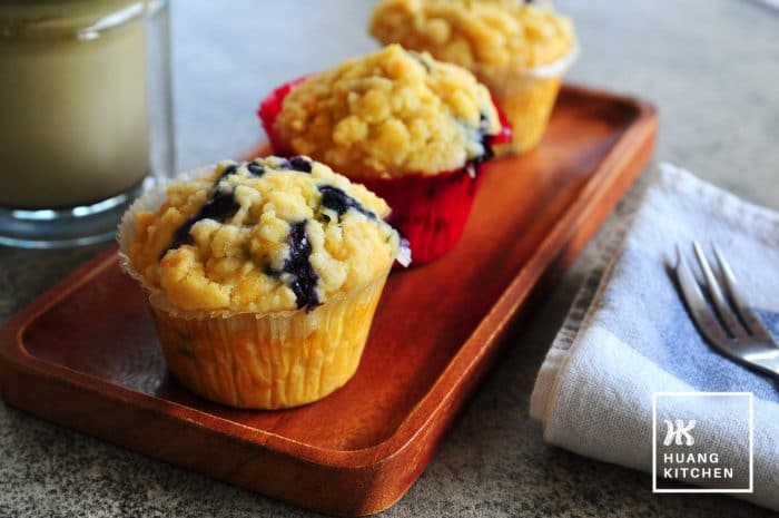 Buttery Blueberry Streusel Muffins Recipe by Huang Kitchen - close up of three crumbly streusel muffins on a plate