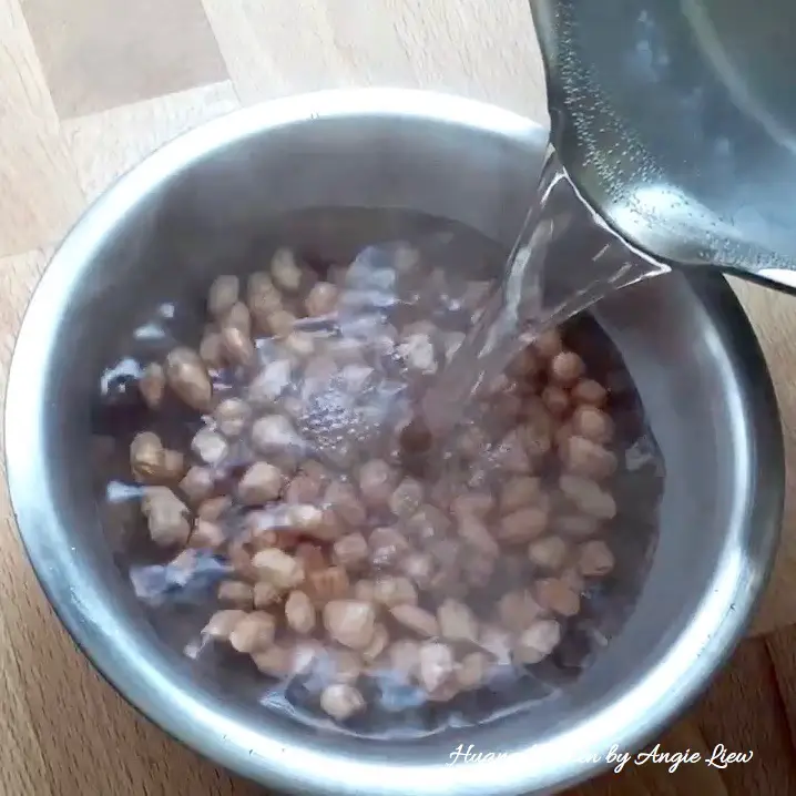 Soak raw peanuts in hot water.