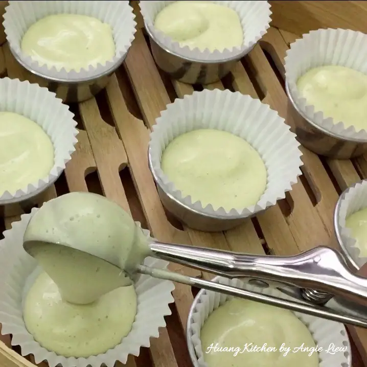 Pour cake batter into cups.