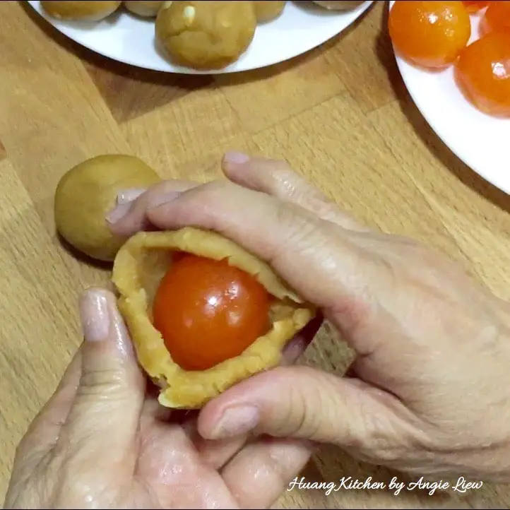 Wrap egg yolk in paste.