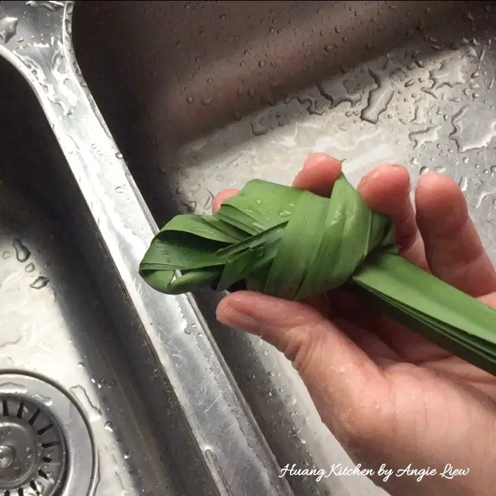 Wash, rinse and knot pandan leaves.