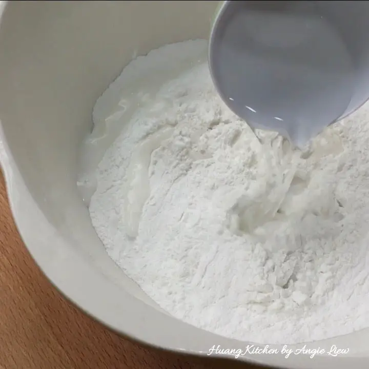 Pour hot boiling water into flour.