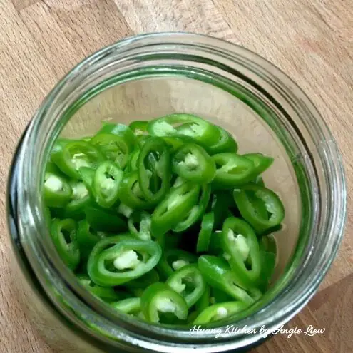 Place chillies in a jar.
