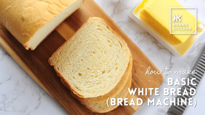 How To Make Basic White Bread with Bread Machine - Recipe Cover Photo Loaf of bread with bread knife and butter