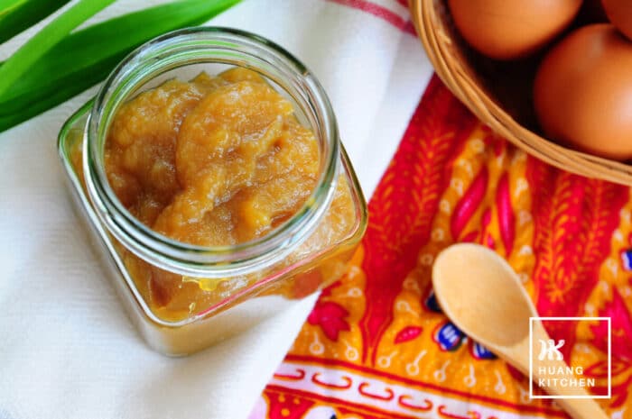 Homemade Caramel Kaya Recipe by Huang Kitchen - Kaya jar top down view with wooden spoon, eggs and batik background