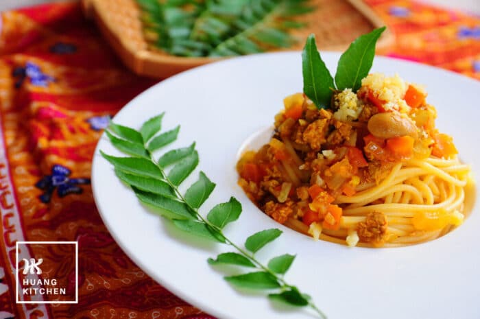 Spaghetti with Curry Meat Sauce (Malaysian Style Bolognese Pasta) Recipe by Huang Kitchen - Plated pasta in deep dish with curry leaves garnishing