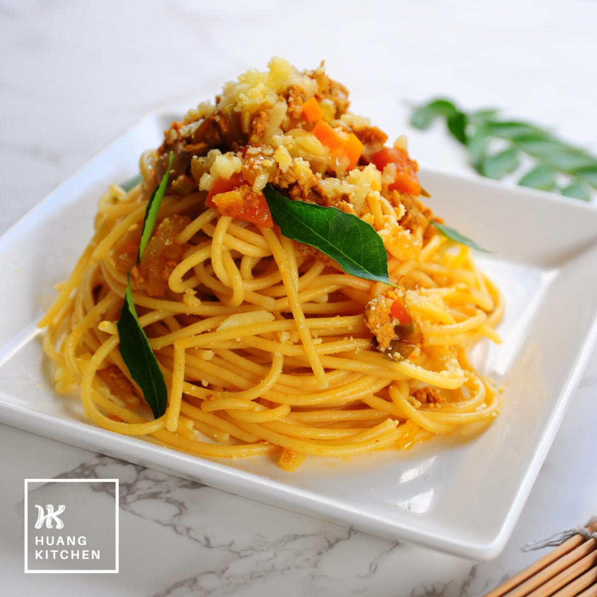 Spaghetti with Curry Meat Sauce (Malaysian Style Bolognese Pasta) Recipe by Huang Kitchen - Square photo of pasta in square plate white background
