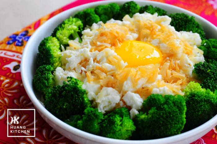 Shanghai Stir Fry Egg Whites With Dried Scallop Recipe (Sai Pang Xie) by Huang Kitchen - Soft egg whites in broccoli ring, topped with sauteed dried scallop and raw egg yolk, batik background