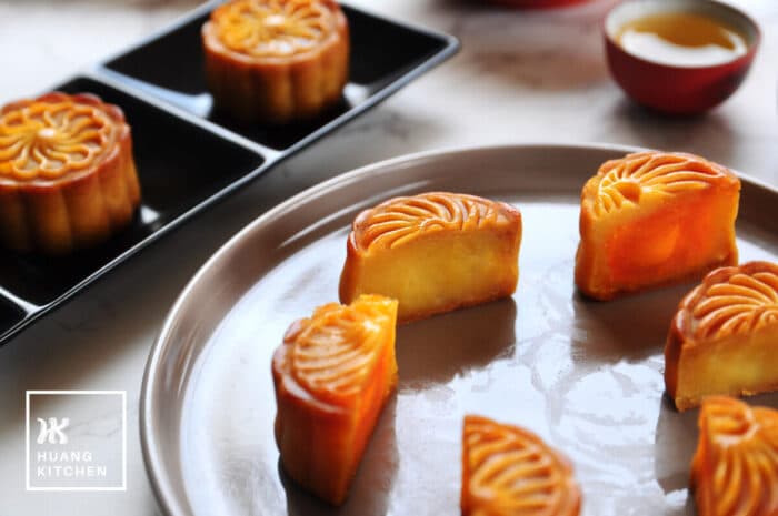 Baked Durian Mung Bean Paste Mooncake Recipe by Huang Kitchen - Cross section view of mooncake cut into halves, with egg yolk filling and without