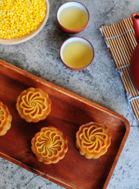 Baked Durian Mung Bean Paste Mooncake Recipe by Huang Kitchen - Top down view of mooncakes with teapot and chinese tea in background