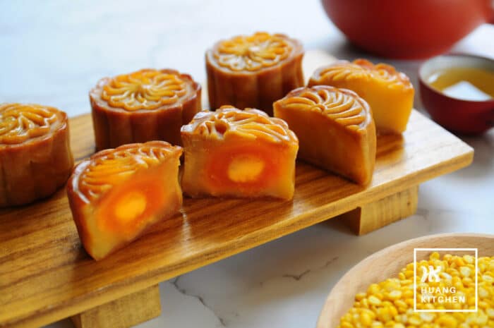 Baked Durian Mung Bean Paste Mooncake Recipe by Huang Kitchen - Cross section of cut mooncakes with salted egg yolk filling in the centre