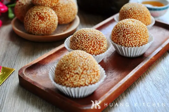 Deep Fried Nian Gao Sesame Balls Recipe by Huang Kitchen - On paper wrapper wooden plate