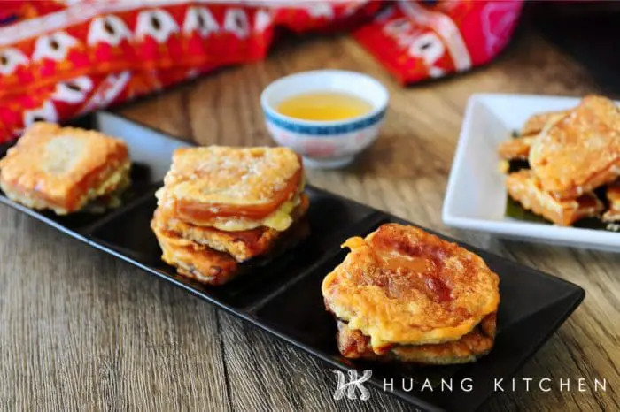 Pan Fried Nian Gao Recipe by Huang Kitchen - Fritters stacked and arranged on plate with chinese tea